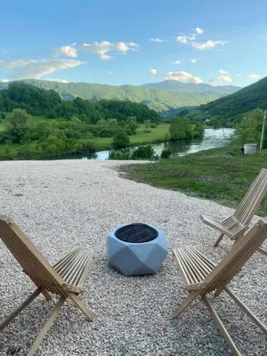 two chairs and a fire pit on top of a hill at Bungalov La Repit in Šipovo