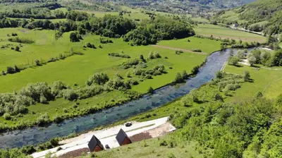 an aerial view of a river in a field at Bungalov La Repit in Šipovo