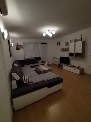 a living room with a couch and a table at Gold Home in Bosanska Gradiška
