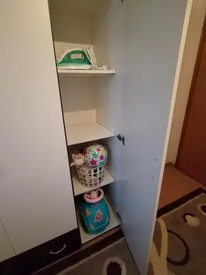 a small closet with a shelf and a basket at Gold Home in Bosanska Gradiška