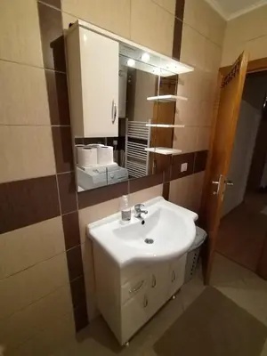 a bathroom with a sink and a mirror at Gold Home in Bosanska Gradiška