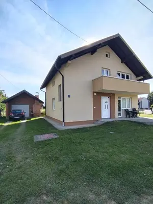 a house with a grass yard in front of it at Gold Home in Bosanska Gradiška