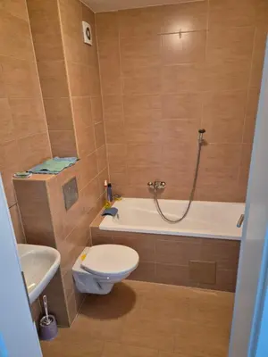 a bathroom with a toilet and a bath tub at The Urbanite in Bihać
