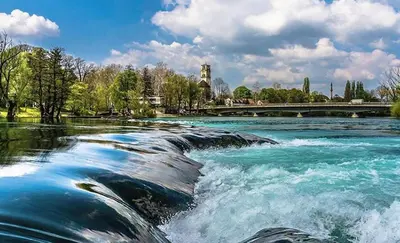 a river with water rapids on a river with a bridge at The Urbanite in Bihać