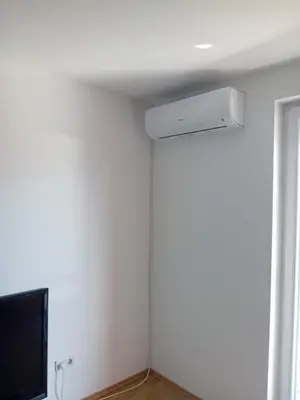 a room with a tv and a white wall at The Urbanite in Bihać