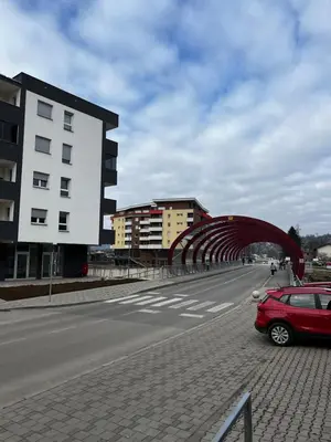 a red car parked on the side of a road at Apartman Nora in Teslić