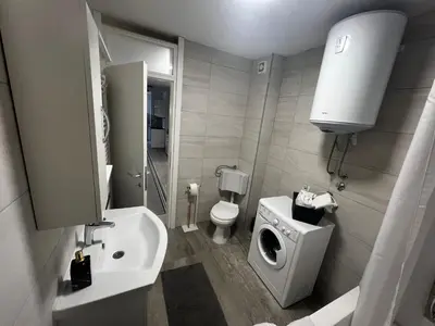 a small bathroom with a toilet and a sink at Apartman Nora in Teslić