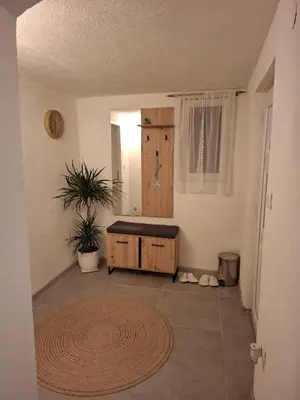 a room with a sink and a rug on the floor at Delux Apartmans in Kulen Vakuf