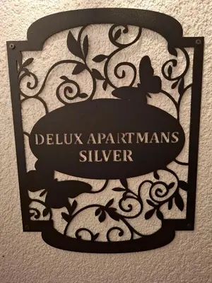a sign that reads deluxarians silver on a wall at Delux Apartmans in Kulen Vakuf