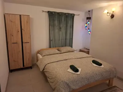 a bedroom with two beds with towels on the bed at Delux Apartmans in Kulen Vakuf