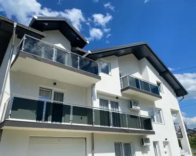 an apartment building with balconies and a blue sky at Apartman Rawda 1 in Jajce