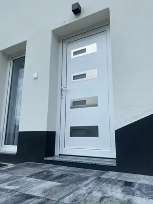 a white door on the side of a building at Apartman Rawda 1 in Jajce