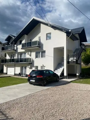 a black car parked in front of a house at Apartman Rawda 1 in Jajce