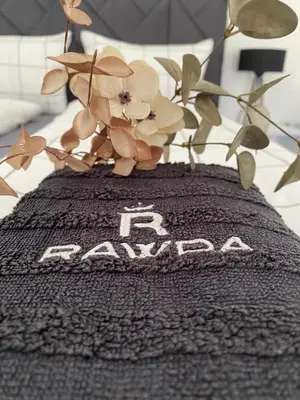 a blanket with flowers on top of it at Apartman Rawda 1 in Jajce