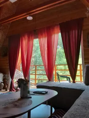 a room with red curtains and a table in front of a window at Visoko Pyramid VALLEY in Visoko