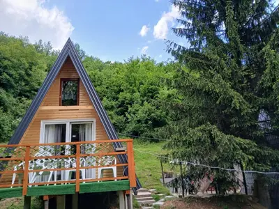 a cabin in the woods with a gambrel roof at Visoko Pyramid VALLEY in Visoko