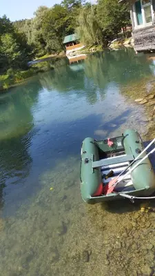 a boat sitting on the shore of a body of water at Villa Janj in Šipovo