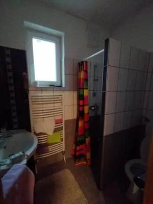 a bathroom with a shower and a sink and a window at Villa Janj in Šipovo