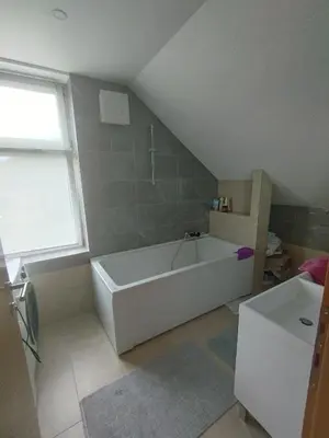 a bathroom with a large white tub and a window at Villa Janj in Šipovo