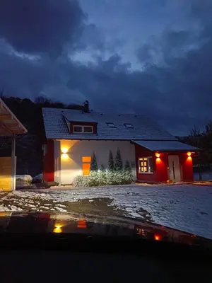 a house with lights on the front of it at night at Villa Janj in Šipovo