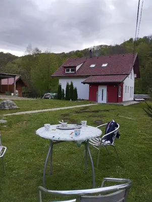 a table and chairs in a yard with a house at Villa Janj in Šipovo