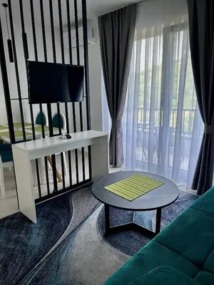 a living room with a couch and a table at Sunny Corner Apartments in Visoko