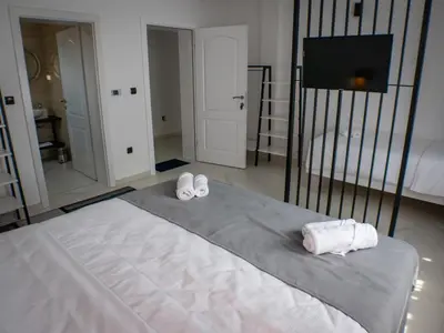 a bedroom with a bed with two towels on it at Sunny Corner Apartments in Visoko