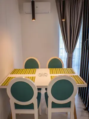 a dining room table with four chairs around it at Sunny Corner Apartments in Visoko