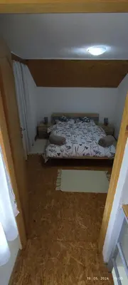 a small room with a bed in a attic at Villa Seferovka in Kulen Vakuf