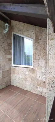 a room with a window on a brick wall at Villa Seferovka in Kulen Vakuf