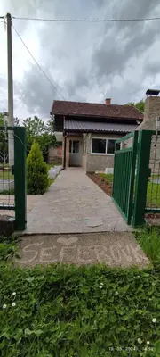 a fence in front of a house with a driveway at Villa Seferovka in Kulen Vakuf