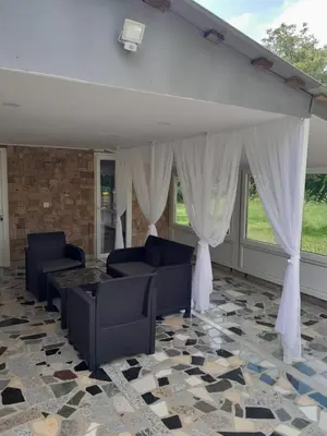 a living room with couches and a table and curtains at Villa Seferovka in Kulen Vakuf