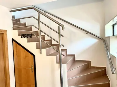 a staircase with steel railings and a glass handrail at Apartman MyHome Travnik in Travnik