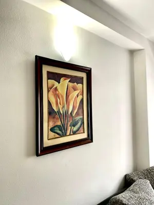 a framed painting of a flower on a wall at Apartman MyHome Travnik in Travnik