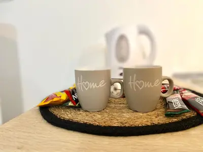 three coffee mugs with the word love written on them at Apartman MyHome Travnik in Travnik