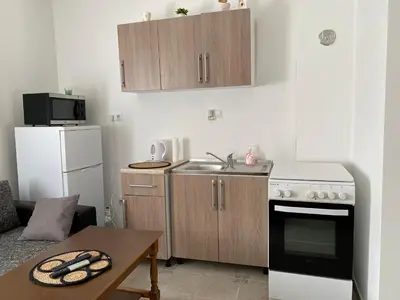 a small kitchen with a sink and a stove at Apartman MyHome Travnik in Travnik