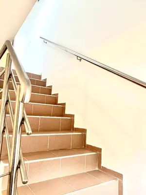 a staircase with a metal handrail and a stair case at Apartman MyHome Travnik in Travnik