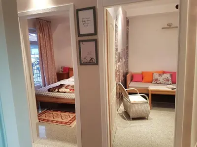 a hallway with a living room with a couch at Adnna Home in Bihać