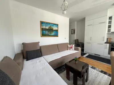a living room with a couch and a table at Apartman Jan in Bihać