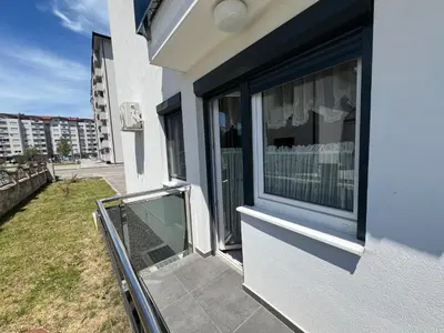 a balcony of a house with a glass door at Apartman Jan in Bihać