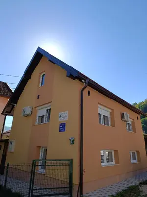 a yellow building with a black roof at Kuća za odmor Majka in Fojnica
