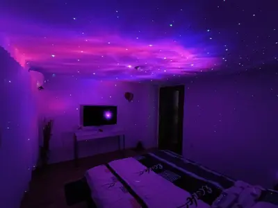 a purple bedroom with a purple ceiling and a tv at Kuća za odmor Majka in Fojnica