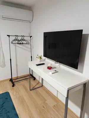 a white table with a flat screen tv on a wall at Kuća za odmor Majka in Fojnica