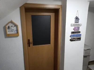a door in a room with signs on it at Kuća za odmor Majka in Fojnica