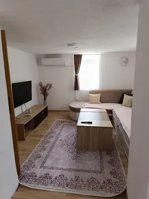 a living room with a bed and a coffee table at Kuća za odmor Majka in Fojnica