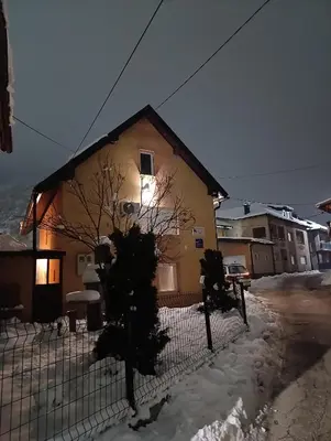 a house with a fence in the snow at Kuća za odmor Majka in Fojnica