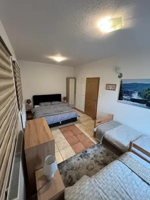 a living room with two beds and a table at Teal Apartment 1 in Bihać