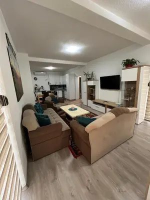 a living room with two couches and a table at Teal Apartment 1 in Bihać