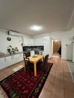 a kitchen and dining room with a table and chairs at Teal Apartment 1 in Bihać