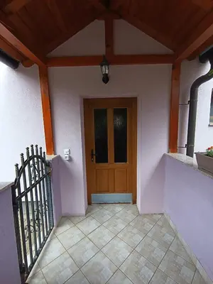 a entrance to a house with a wooden door at Apartman EMA in Kulen Vakuf
